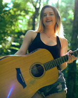 Sarah Morey Strumming a Guitar